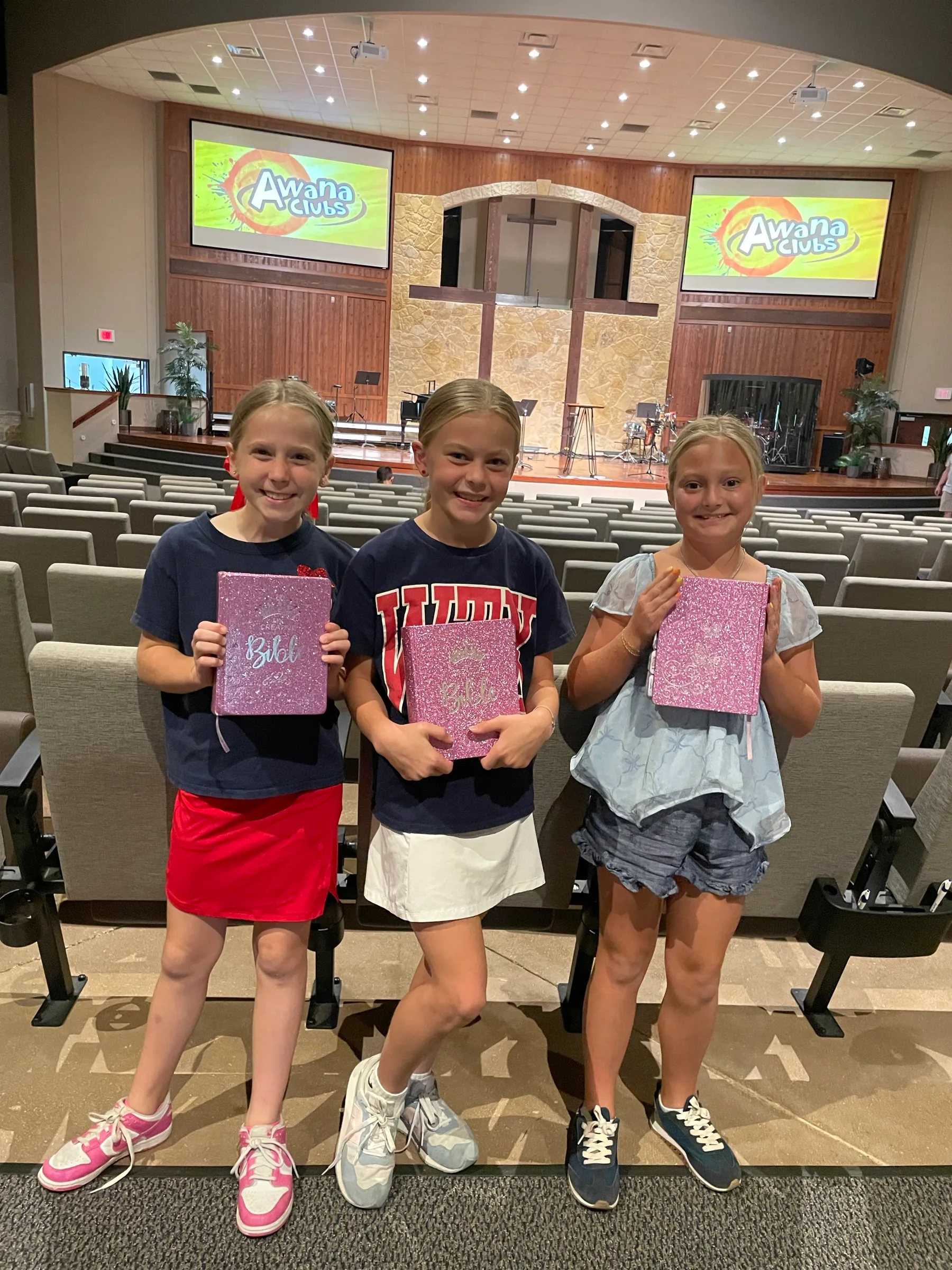 Children holding Bibles at AWANA Club